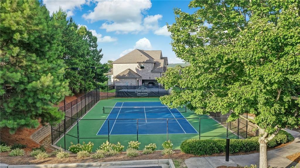 2391 Hopehaven Way Hoschton, GA 30548 - Photo 82 of 87 a front view of a house with a yard and potted plants