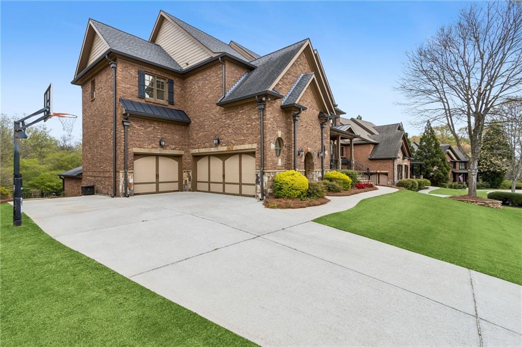 2391 Hopehaven Way Hoschton, GA 30548 - Photo 87 of 87 a front view of a house with a garden and plants
