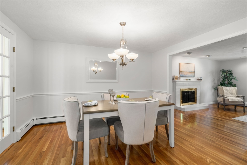 18 Julia Road Needham, MA 02492 - Photo 15 of 41 a dining room with furniture a chandelier and wooden floor