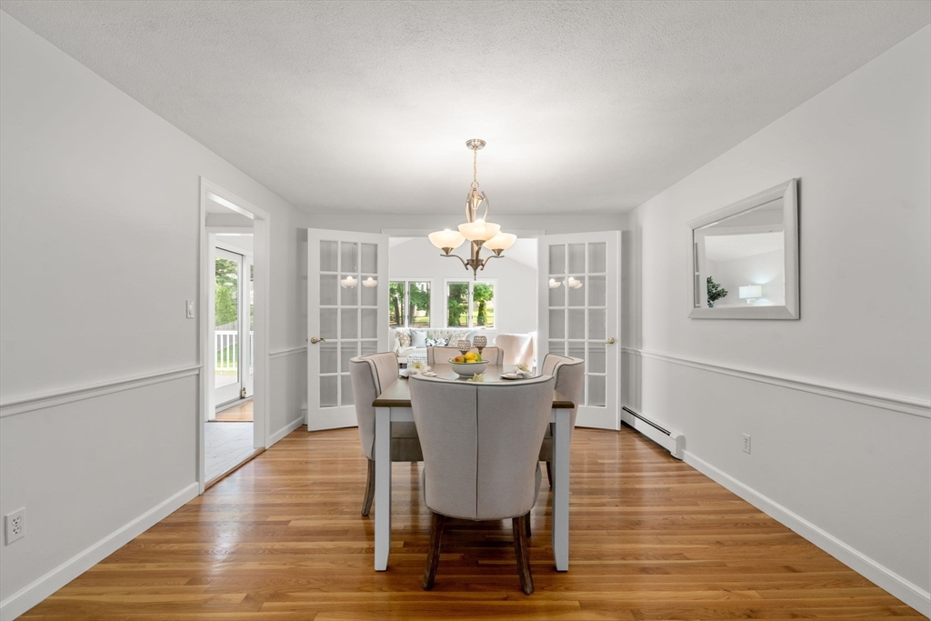 18 Julia Road Needham, MA 02492 - Photo 16 of 41 a dining room with furniture a chandelier and wooden floor