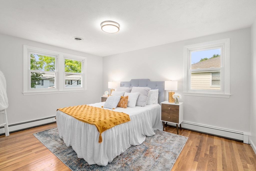 18 Julia Road Needham, MA 02492 - Photo 17 of 41 a bedroom with a bed and wooden floor