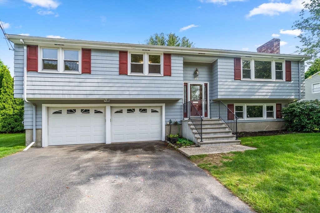 18 Julia Road Needham, MA 02492 - Photo 2 of 41 a front view of a house with a yard and garage