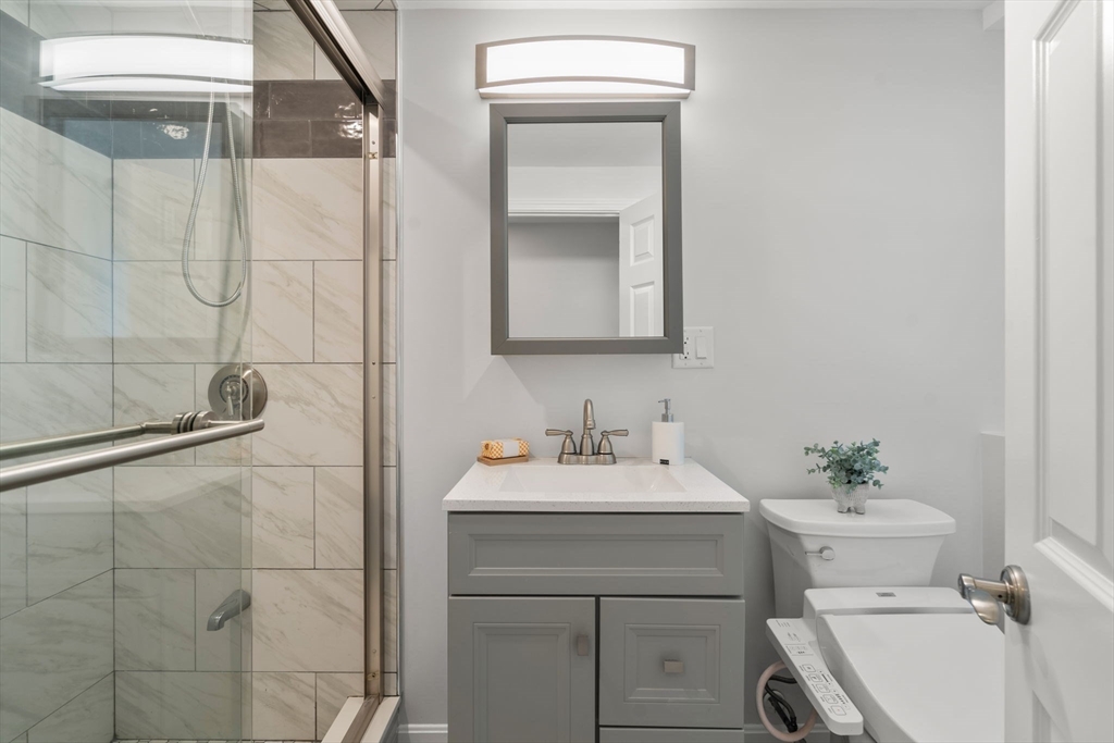 18 Julia Road Needham, MA 02492 - Photo 23 of 41 a bathroom with a sink toilet and shower