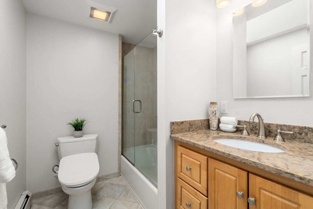 18 Julia Road Needham, MA 02492 - Photo 24 of 41 a bathroom with a granite countertop toilet sink and mirror