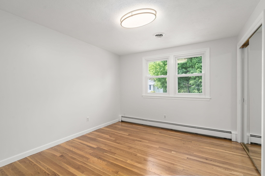 18 Julia Road Needham, MA 02492 - Photo 26 of 41 an empty room with wooden floor and windows