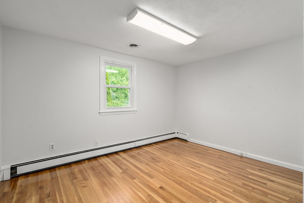 18 Julia Road Needham, MA 02492 - Photo 27 of 41 wooden floor in an empty room with a window