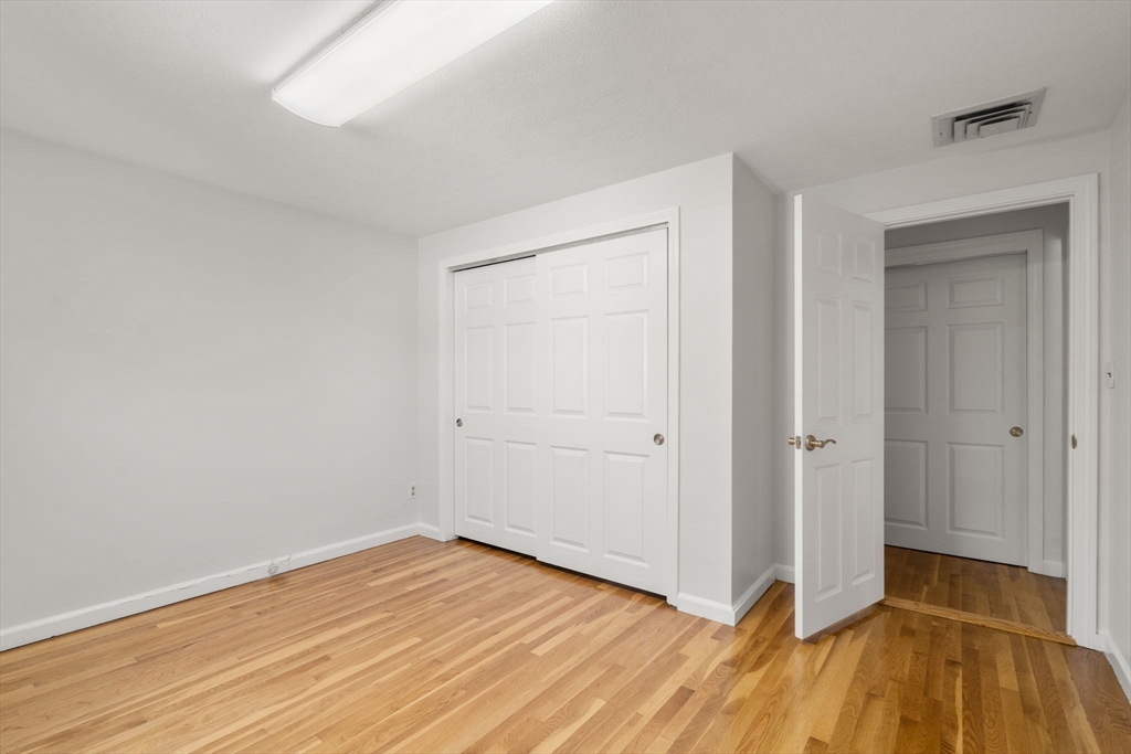 18 Julia Road Needham, MA 02492 - Photo 28 of 41 a view of an empty room with wooden floor and a window