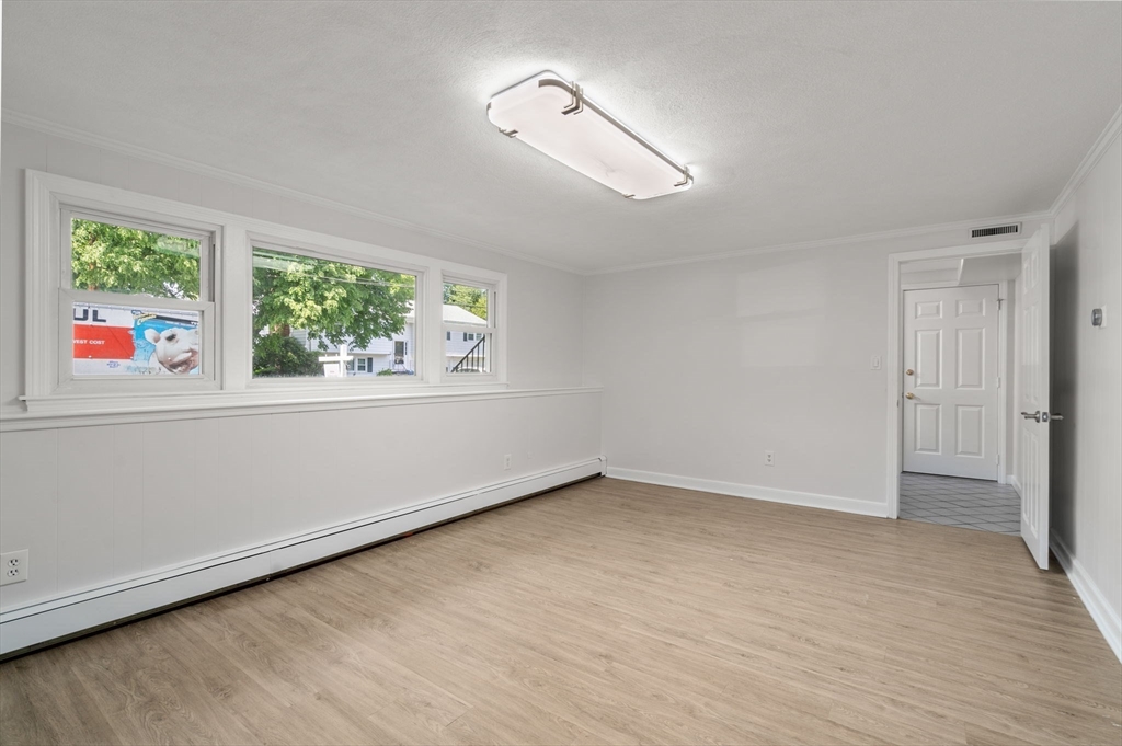 18 Julia Road Needham, MA 02492 - Photo 33 of 41 a view of an empty room with wooden floor and a window
