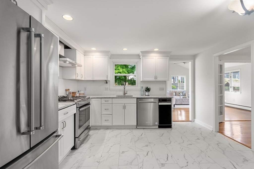 18 Julia Road Needham, MA 02492 - Photo 5 of 41 a kitchen with stainless steel appliances granite countertop a refrigerator and a stove top oven