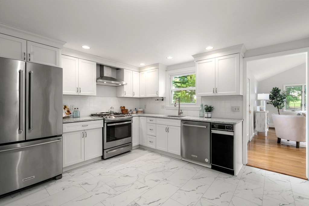 18 Julia Road Needham, MA 02492 - Photo 6 of 41 a kitchen with granite countertop stainless steel appliances and white cabinets