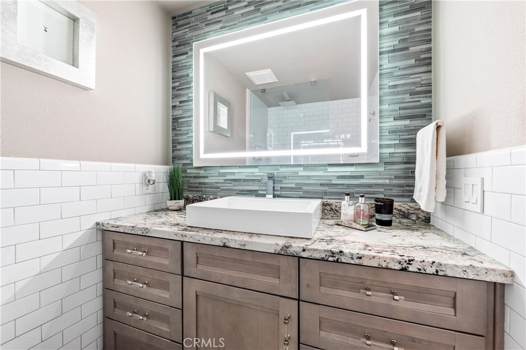 17294 Citron Irvine, CA 92612 - Photo 19 of 26 a bathroom with a granite countertop sink and a mirror