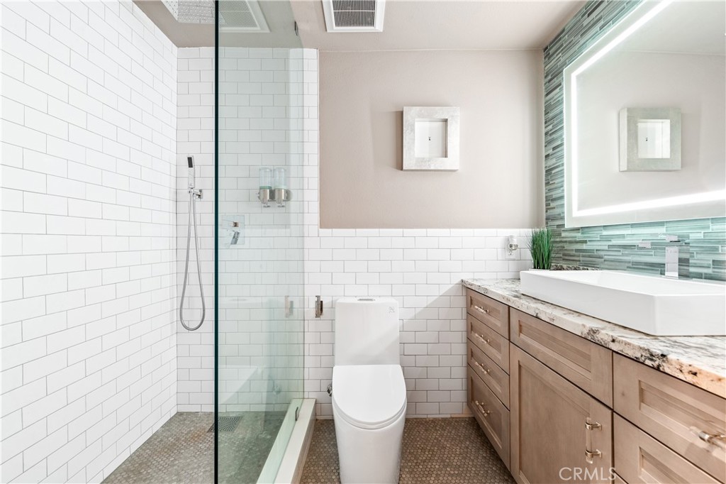 17294 Citron Irvine, CA 92612 - Photo 20 of 26 a bathroom with a granite countertop sink toilet and shower