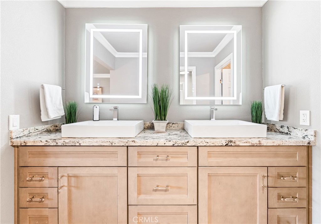 17294 Citron Irvine, CA 92612 - Photo 4 of 26 a bathroom with a granite countertop sink and a mirror