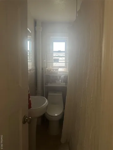 a kitchen with white cabinets and appliances