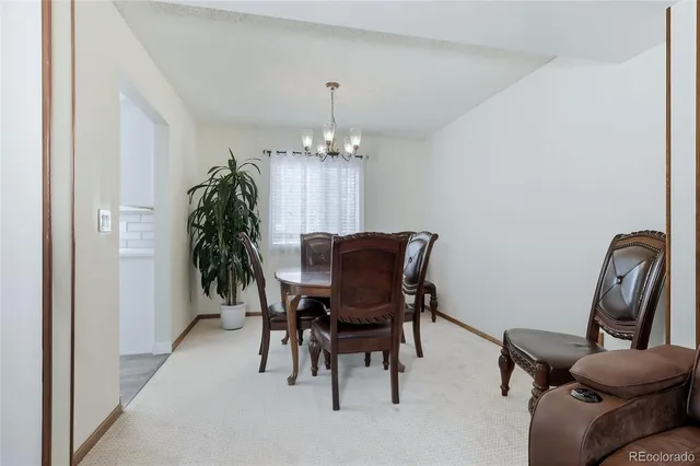 a view of a dining room with furniture and chandelier
