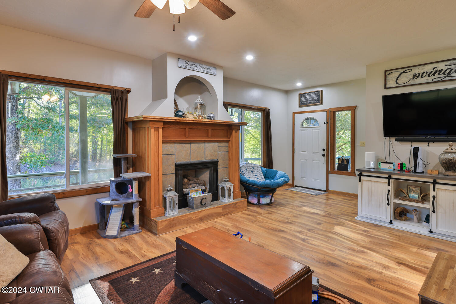 433 Jolly Springs Road Dresden, TN 38225 - Photo 6 of 64 a living room with furniture a flat screen tv and a fireplace