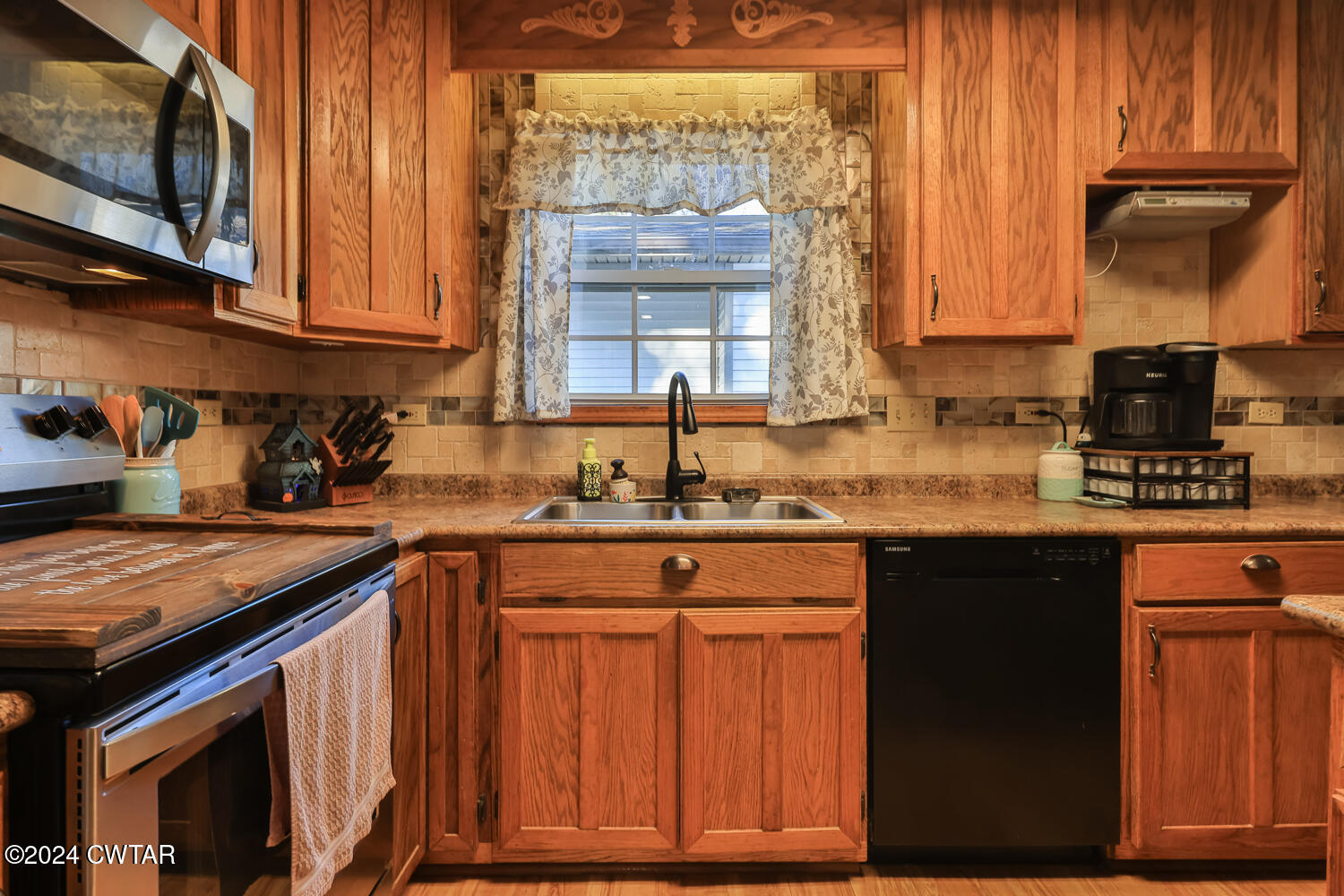 433 Jolly Springs Road Dresden, TN 38225 - Photo 8 of 64 a kitchen with stainless steel appliances granite countertop wooden cabinets a sink and dishwasher