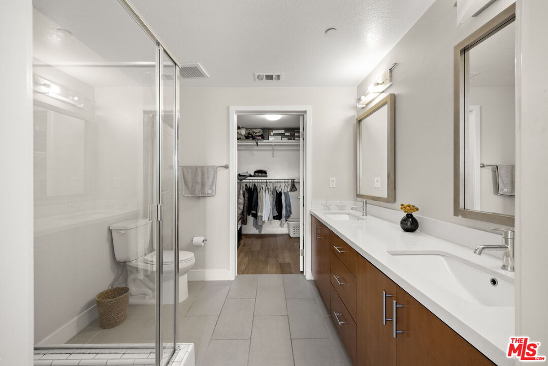 13337 Beach Avenue, Unit 406 Marina del Rey, CA 90292 - Photo 12 of 23 a bathroom with a double vanity sink mirror and shower