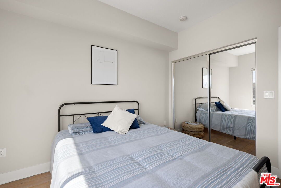13337 Beach Avenue, Unit 406 Marina del Rey, CA 90292 - Photo 17 of 23 a bedroom with a bed and a mirror