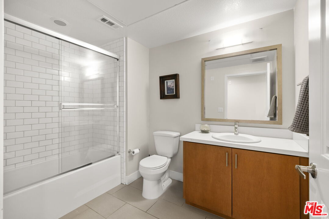 13337 Beach Avenue, Unit 406 Marina del Rey, CA 90292 - Photo 19 of 23 a bathroom with a sink a toilet and shower