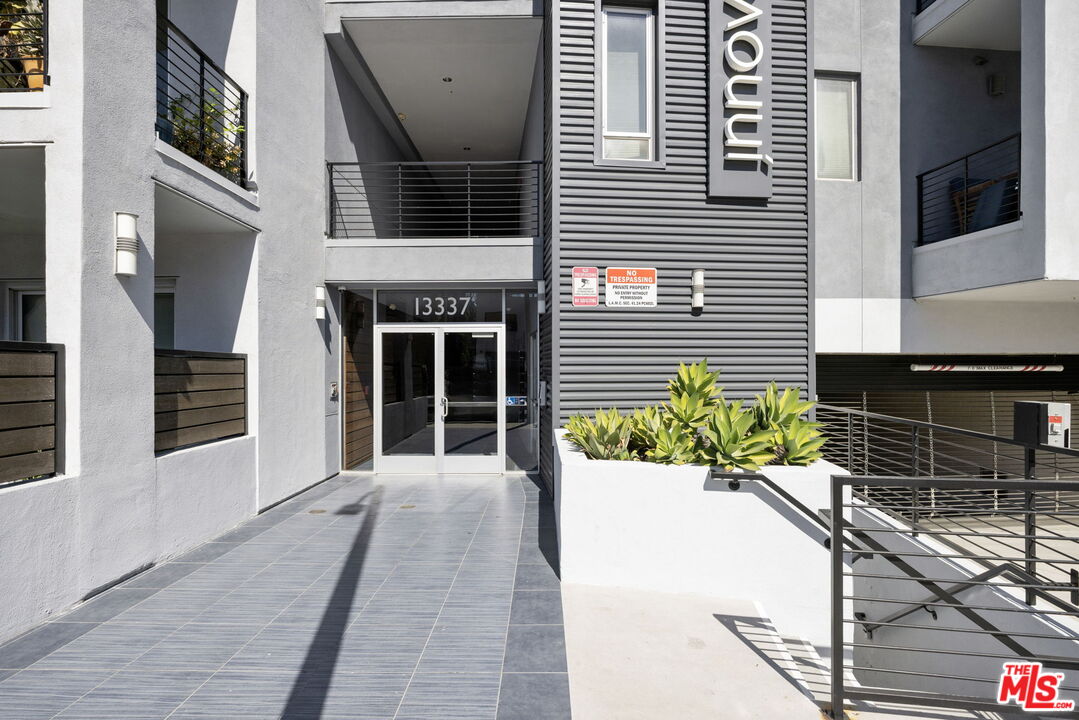13337 Beach Avenue, Unit 406 Marina del Rey, CA 90292 - Photo 4 of 23 a front view of a house with a yard