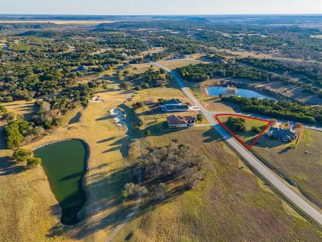 an aerial view of a house with a lake view