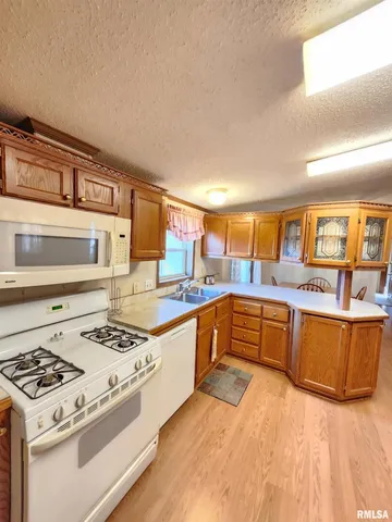an empty room with windows and cabinet