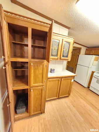 a view of a room with wooden floor and door