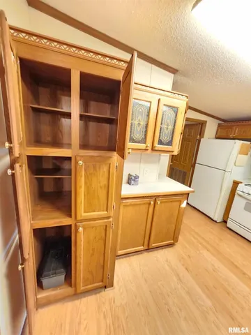 a view of a room with wooden floor and door