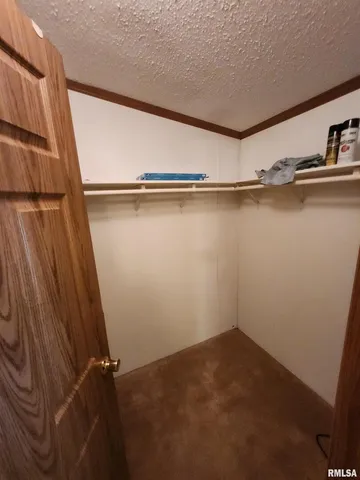 a view of a livingroom with furniture and a kitchen