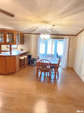 a view of a dining room with furniture and chandelier