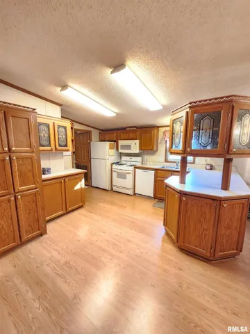 a kitchen with stainless steel appliances granite countertop a refrigerator and a stove