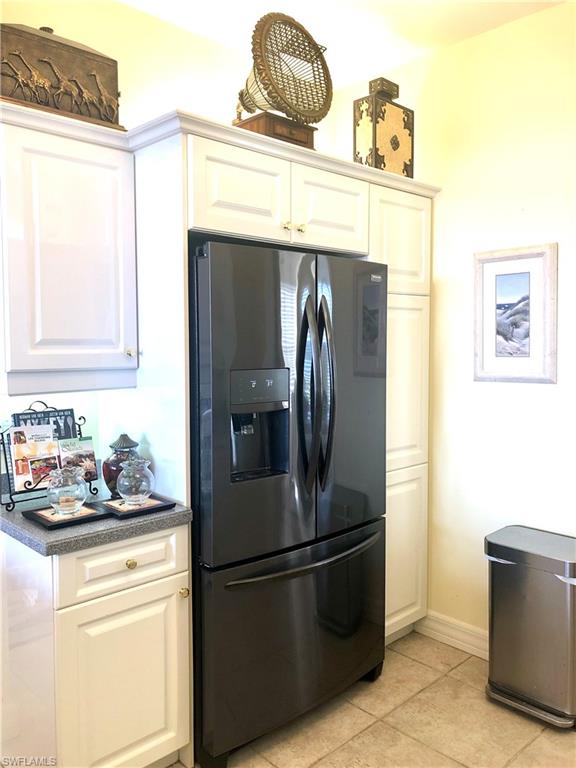 451 Bayfront Place, Unit 5311 Naples, FL 34102 - Photo 15 of 38 a kitchen with a refrigerator and cabinets