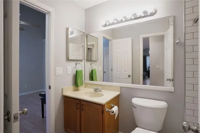 a bathroom with a toilet sink and mirror