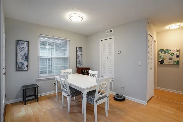 a view of a dining room with furniture window and wooden floor