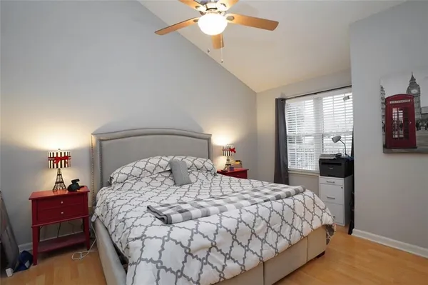 a bedroom with a large bed and a chandelier