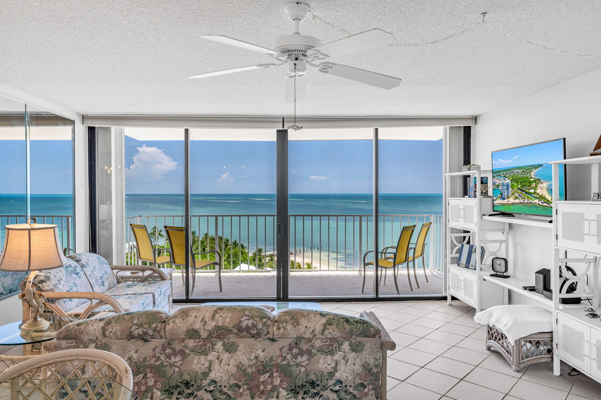 2000 Coco Plum Drive, Unit 1202 Marathon, FL 33050 - Photo 15 of 44 a view of a bedroom with furniture and large windows