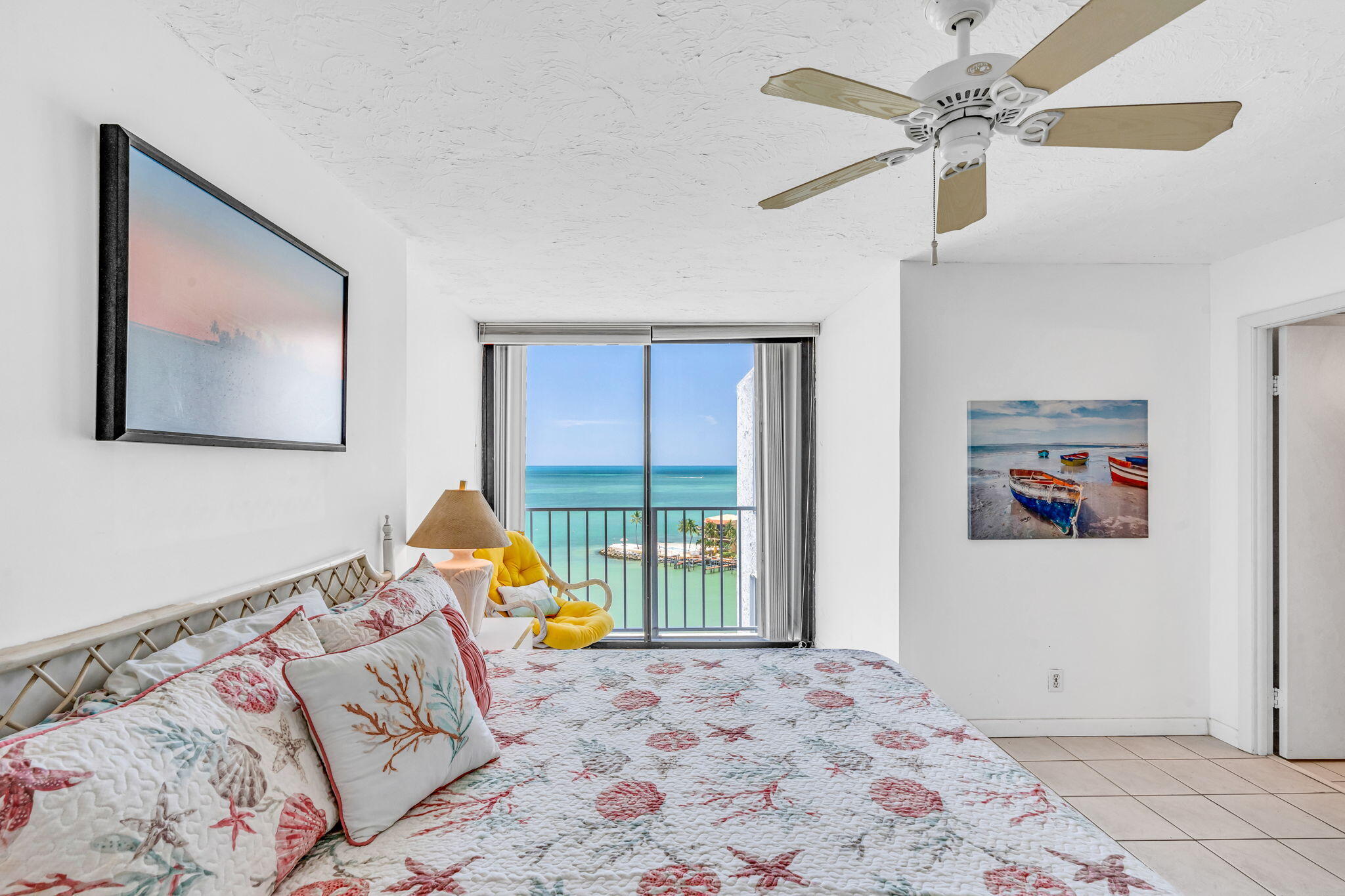 2000 Coco Plum Drive, Unit 1202 Marathon, FL 33050 - Photo 20 of 44 a bedroom with a bed and a painting on the wall