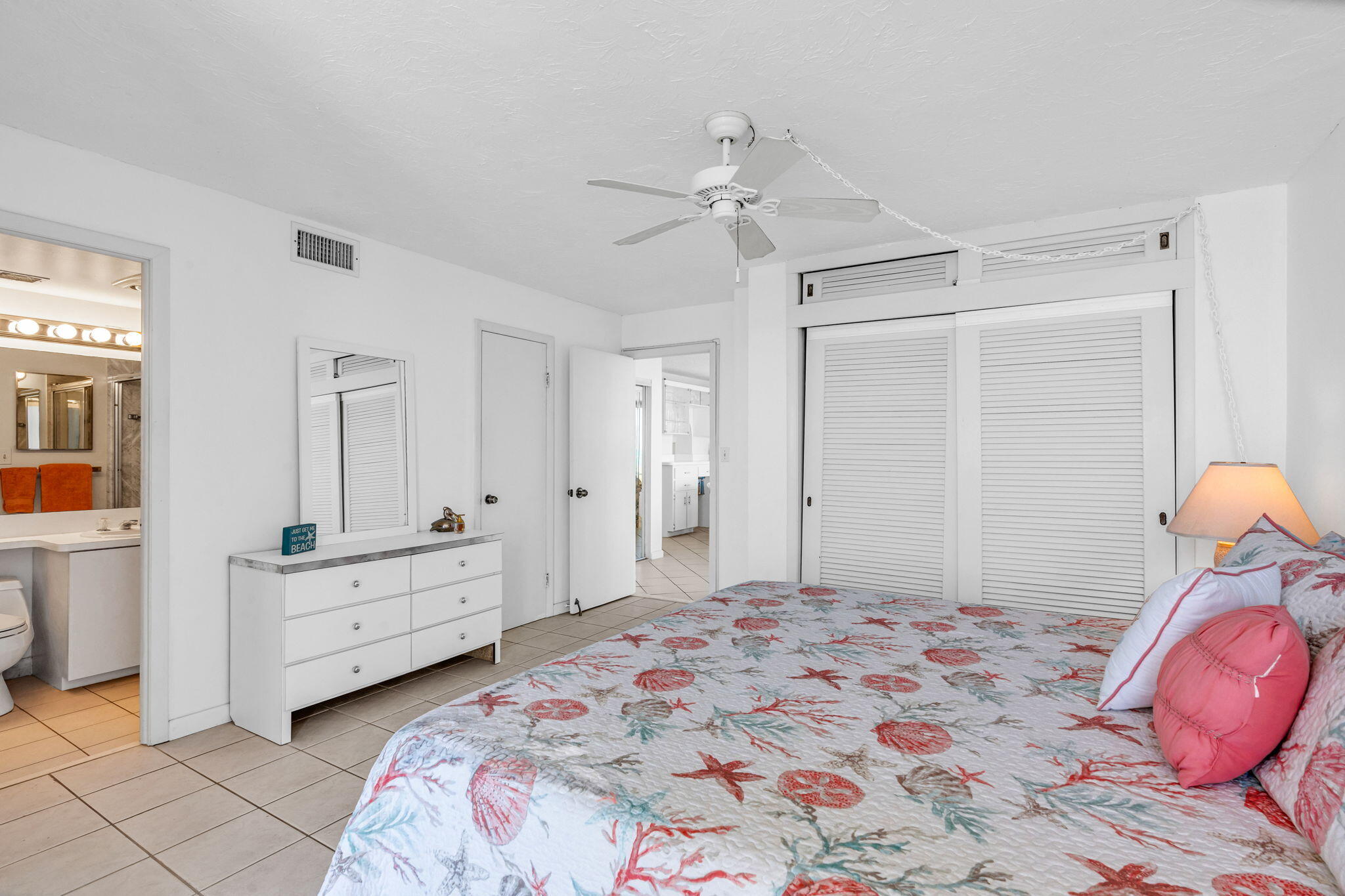 2000 Coco Plum Drive, Unit 1202 Marathon, FL 33050 - Photo 22 of 44 a bedroom with a bed and a chandelier