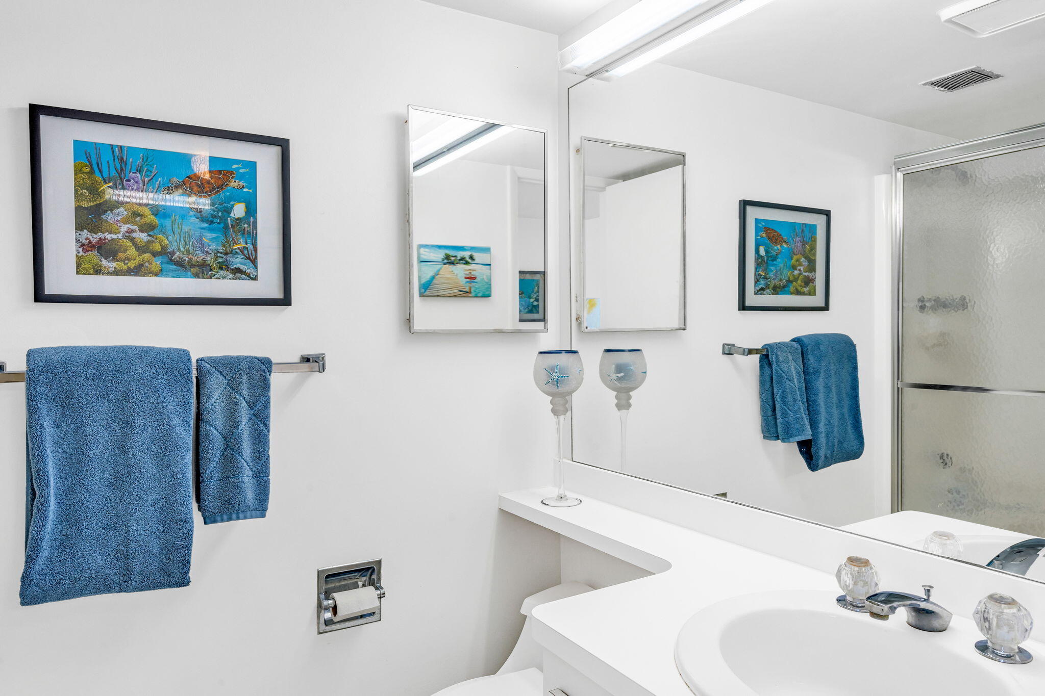 2000 Coco Plum Drive, Unit 1202 Marathon, FL 33050 - Photo 25 of 44 a bathroom with a sink mirror and toilet