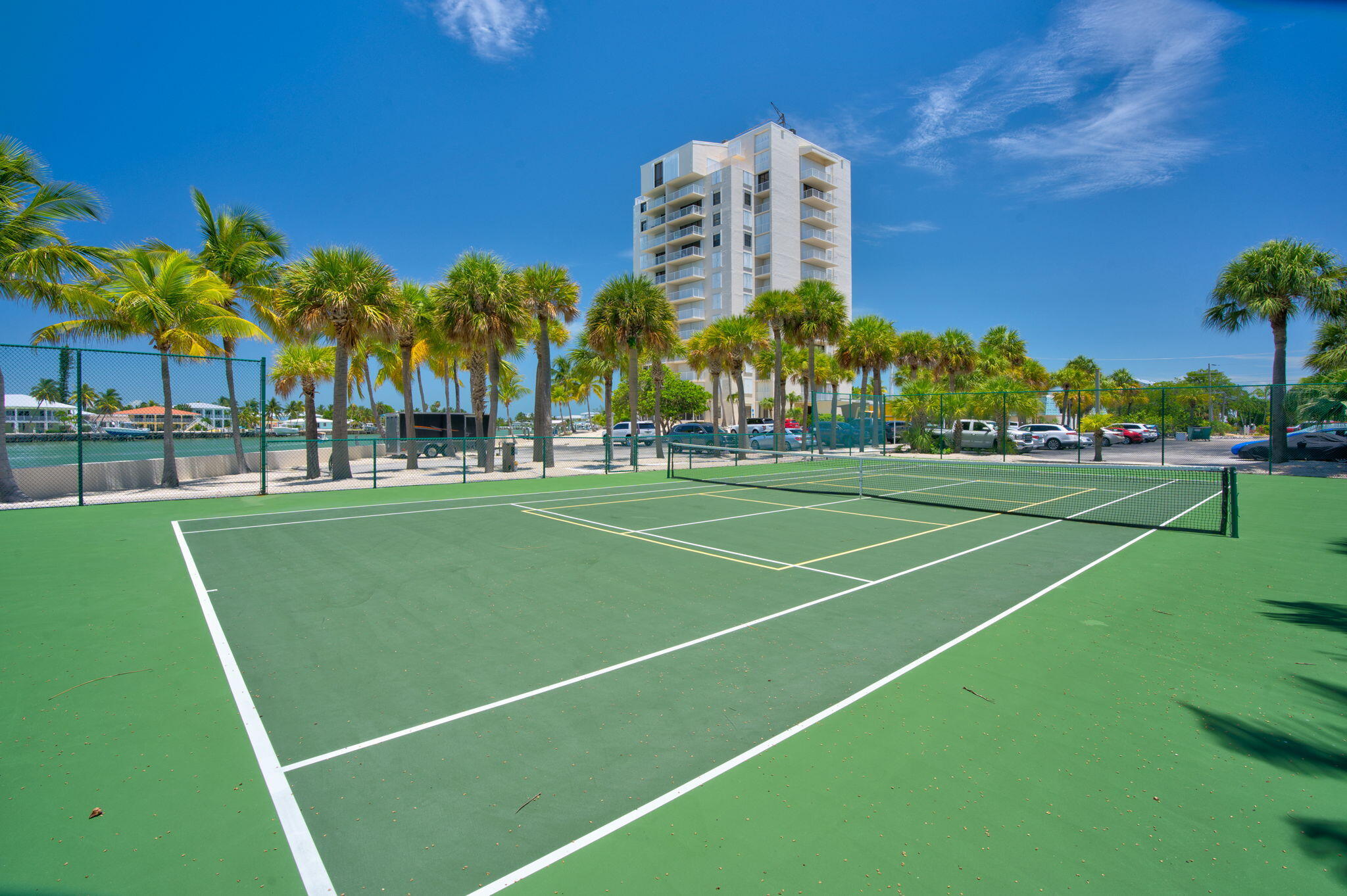 2000 Coco Plum Drive, Unit 1202 Marathon, FL 33050 - Photo 33 of 44 a view of a tennis ground with large trees