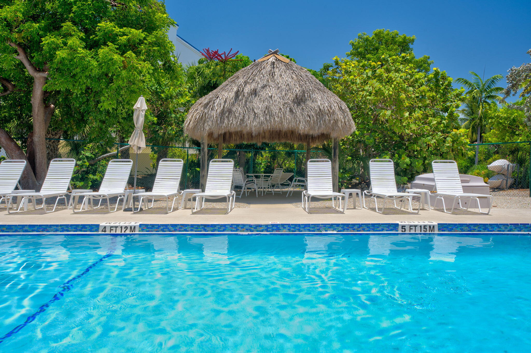 2000 Coco Plum Drive, Unit 1202 Marathon, FL 33050 - Photo 38 of 44 a swimming pool with outdoor seating and yard