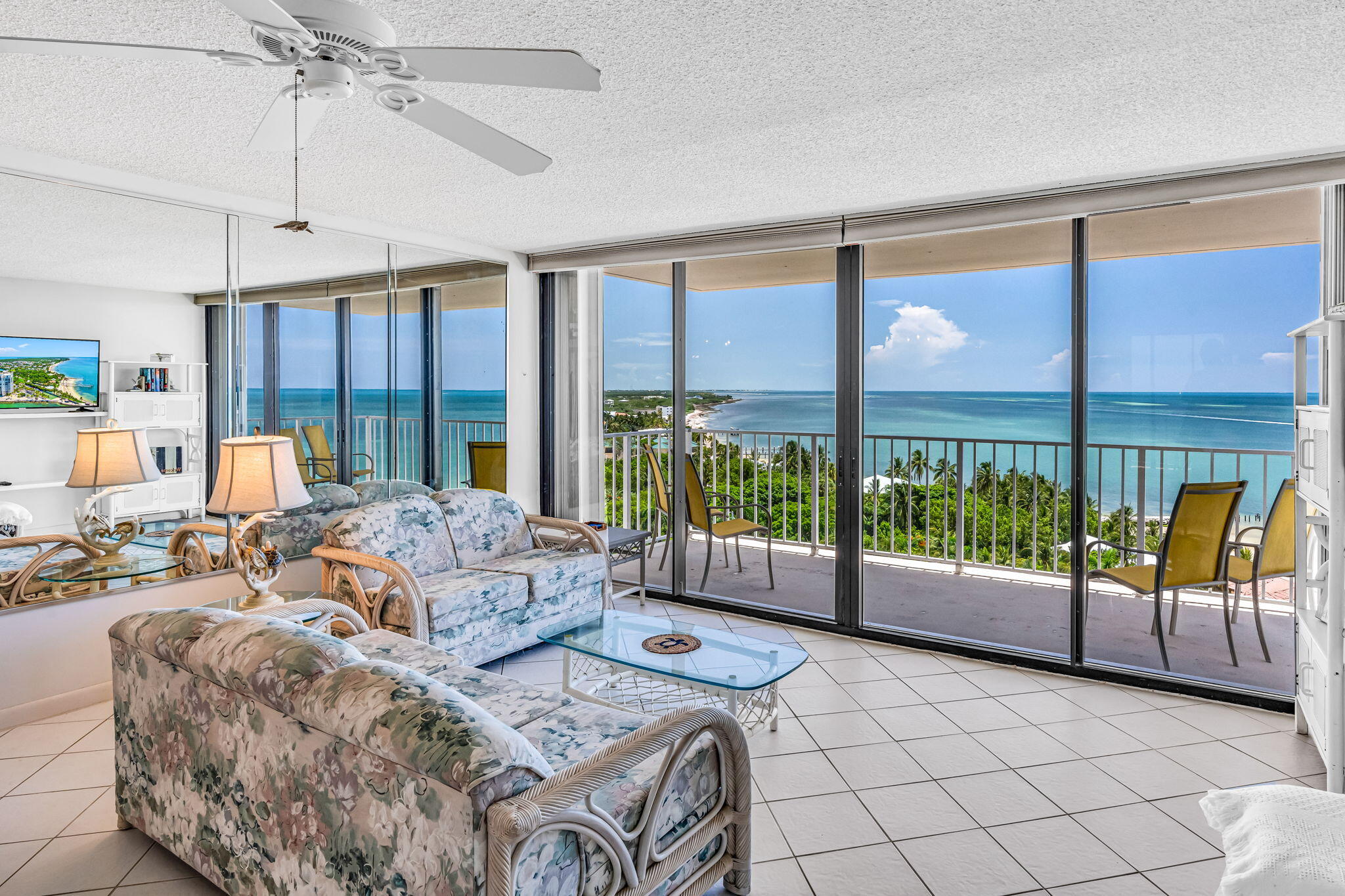 2000 Coco Plum Drive, Unit 1202 Marathon, FL 33050 - Photo 8 of 44 a living room with furniture and a floor to ceiling window