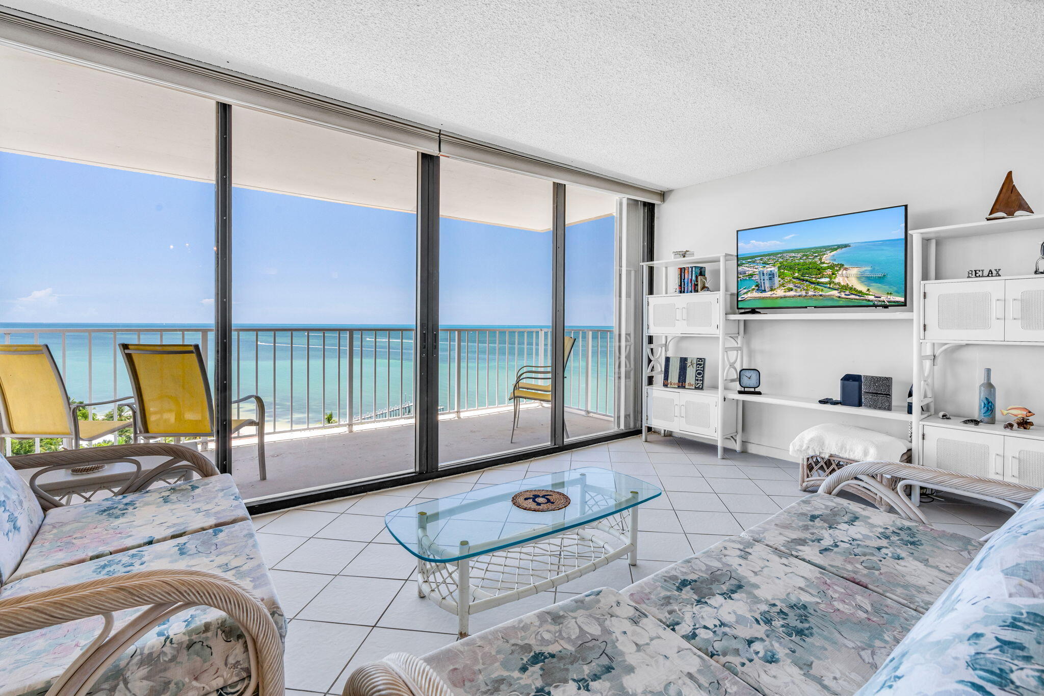2000 Coco Plum Drive, Unit 1202 Marathon, FL 33050 - Photo 9 of 44 a living room with furniture and a floor to ceiling window