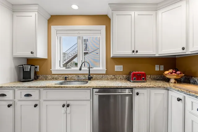 a stove top oven sitting inside of a kitchen and granite counter tops
