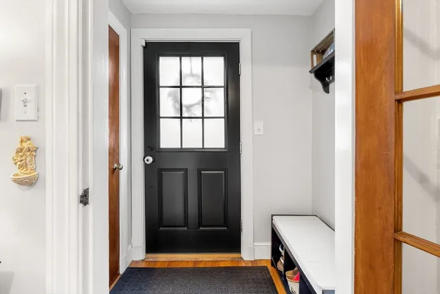 a view of a hallway with wooden floor and entryway
