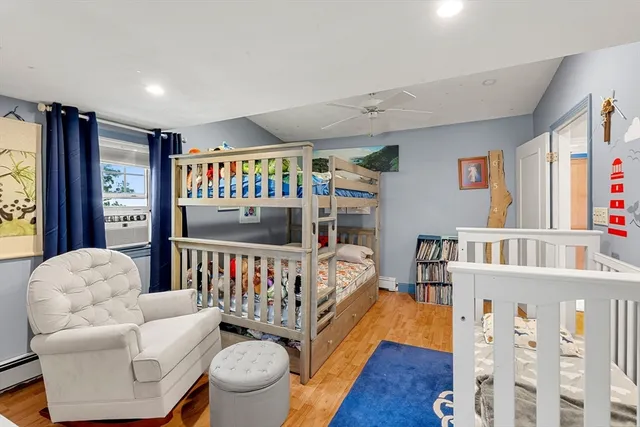 a living room with furniture a rug and a book shelf