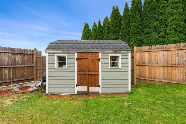 a view of a house with a yard and fence