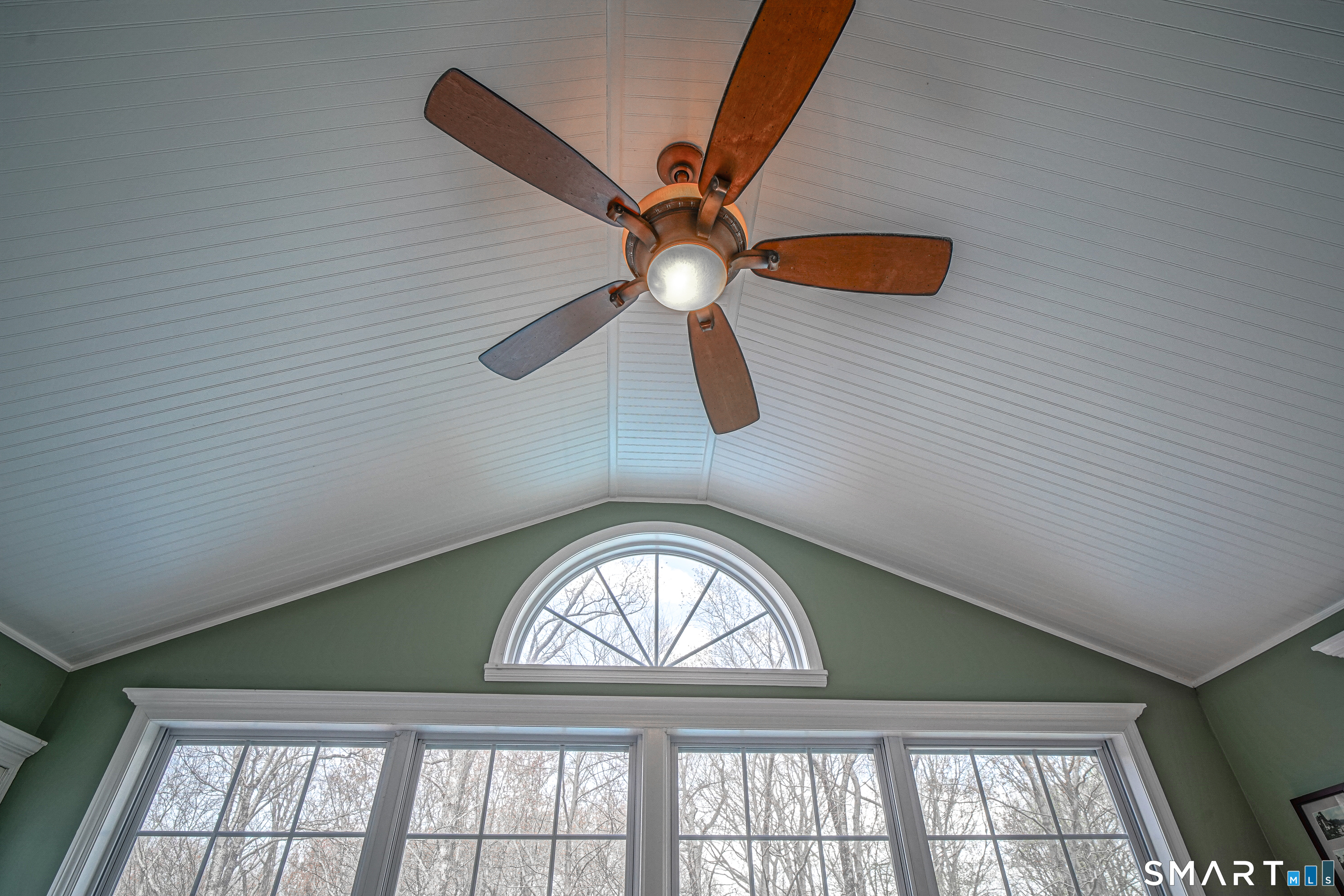 20 Stephen Court Prospect, CT 06712 - Photo 10 of 39 Vaulted ceilings, paldum window, and ceiling fan in bright sunroom