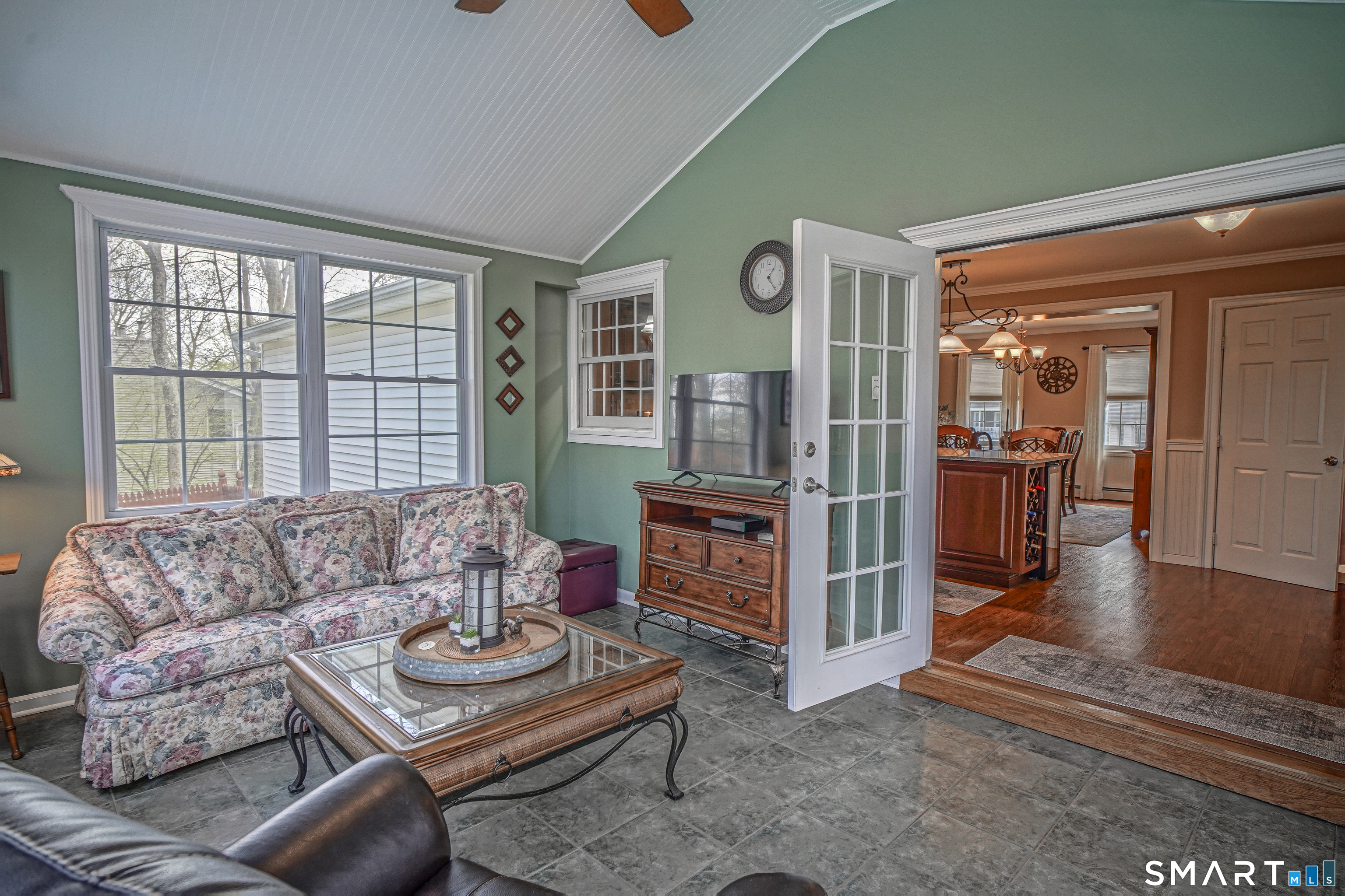 20 Stephen Court Prospect, CT 06712 - Photo 11 of 39 The sunroom features a high ceiling with a fan and separate electrical heating, making it suitable for all four seasons.